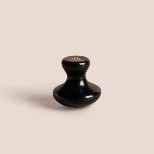 Single Cult of Reason Skincare Gua Sha Stone with pink background