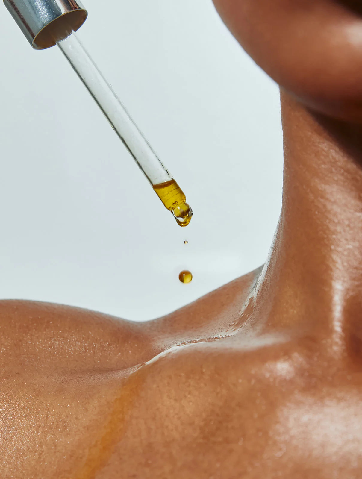 Vitamin C, Plant-Based Retinol Alternative Bakuchiol, Anti-Oxidant Rich Facial Oil Putting Serum on Neck