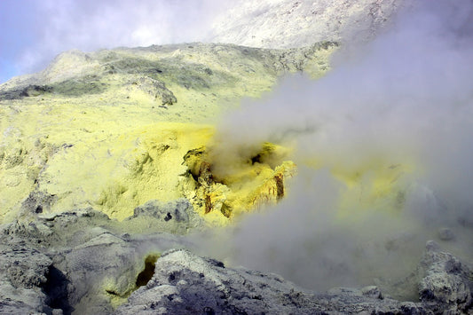 Bright yellow sulfur deposits around the mouth of a volcano.