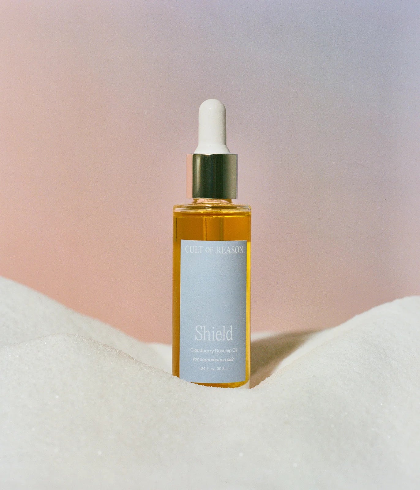 Picture of Cult of Reason Skincare's Anti-aging facial oil bottle with plant-based retinol with pink background