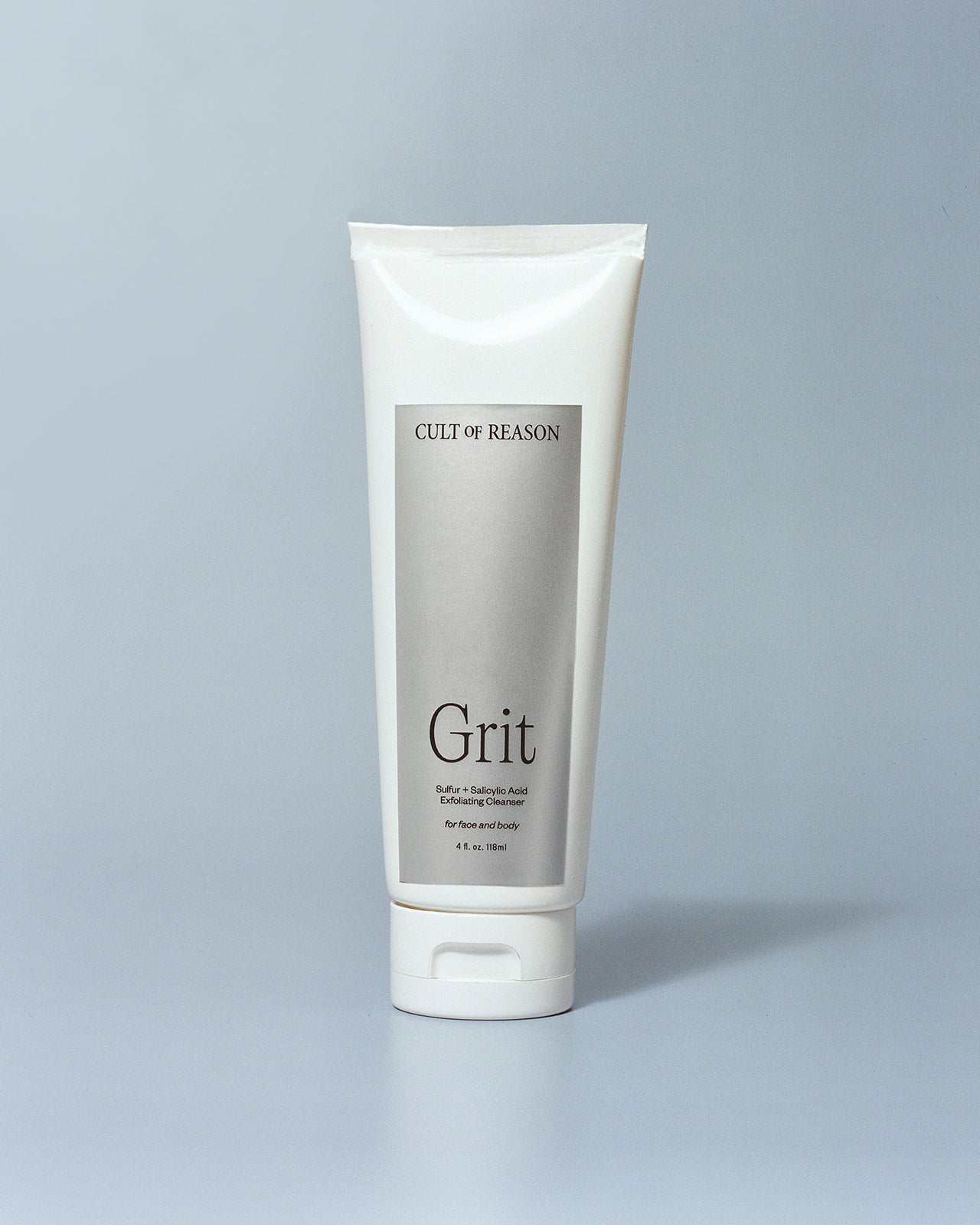 Image of Cult of Reason skincare product Grit, a sulfur and salicylic acid based facial scrub, on a light blue background